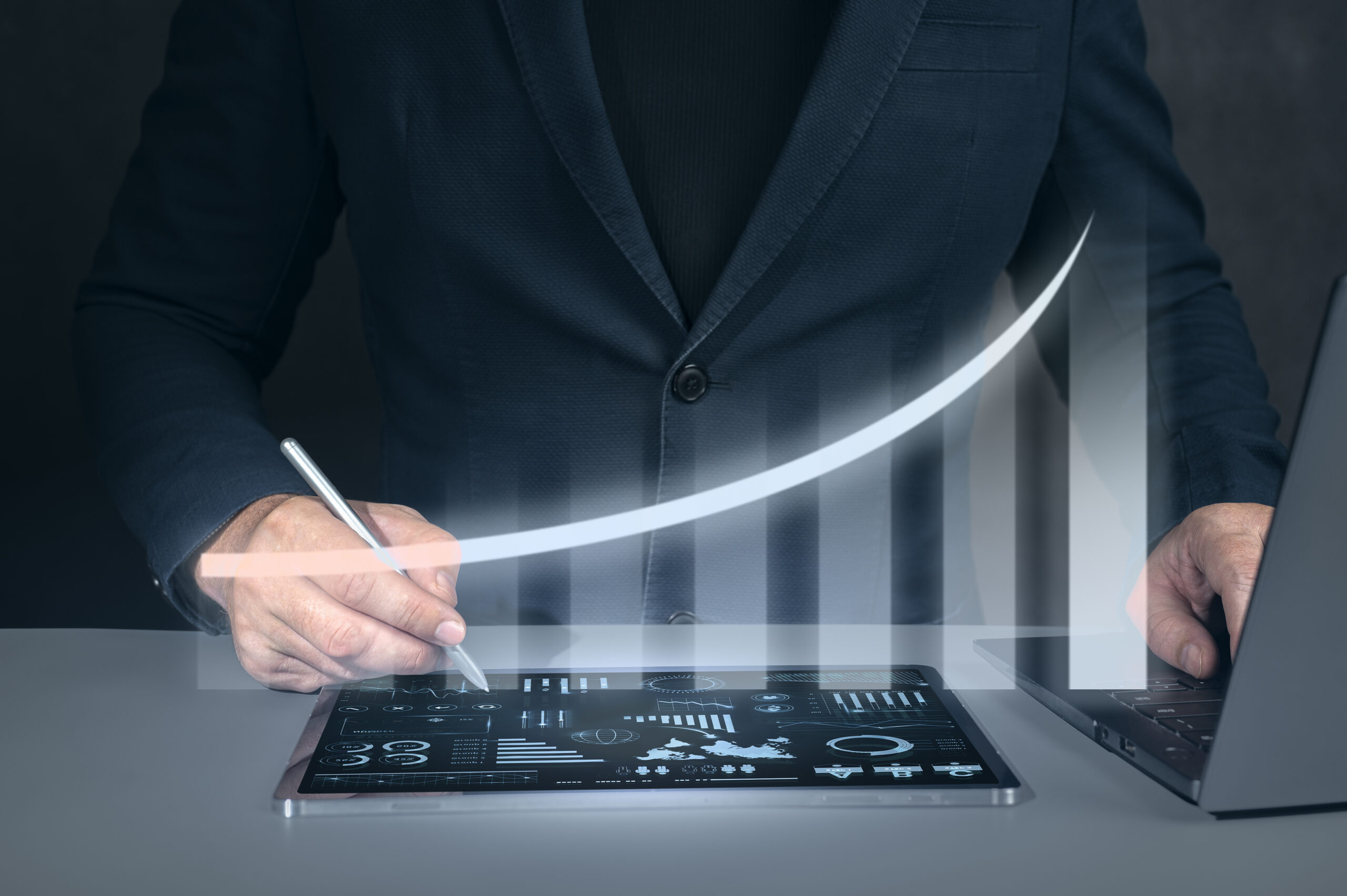 Businessman using tablet analyzing sales data and economic growth graph chart. Business strategy, financial and banking. Digital marketing.