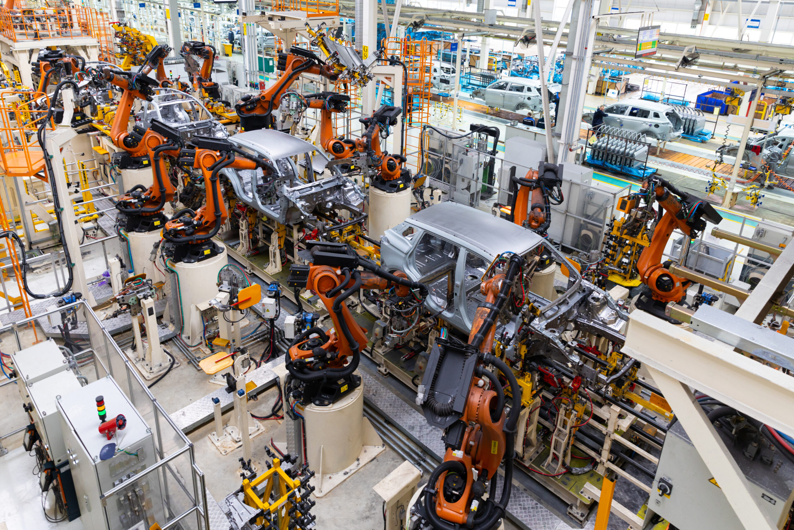 Car bodies are on assembly line. Factory for production of cars. Modern automotive industry. Electric car factory, conveyor