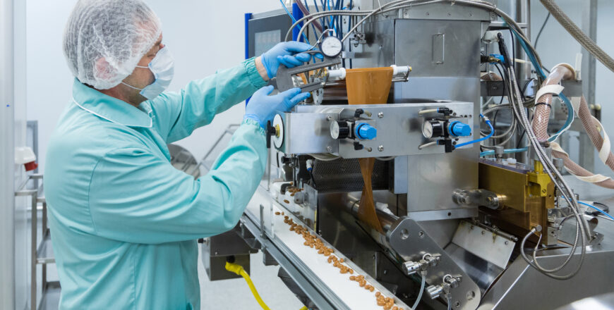 Pharmacy industry factory man worker in protective clothing in sterile working conditions