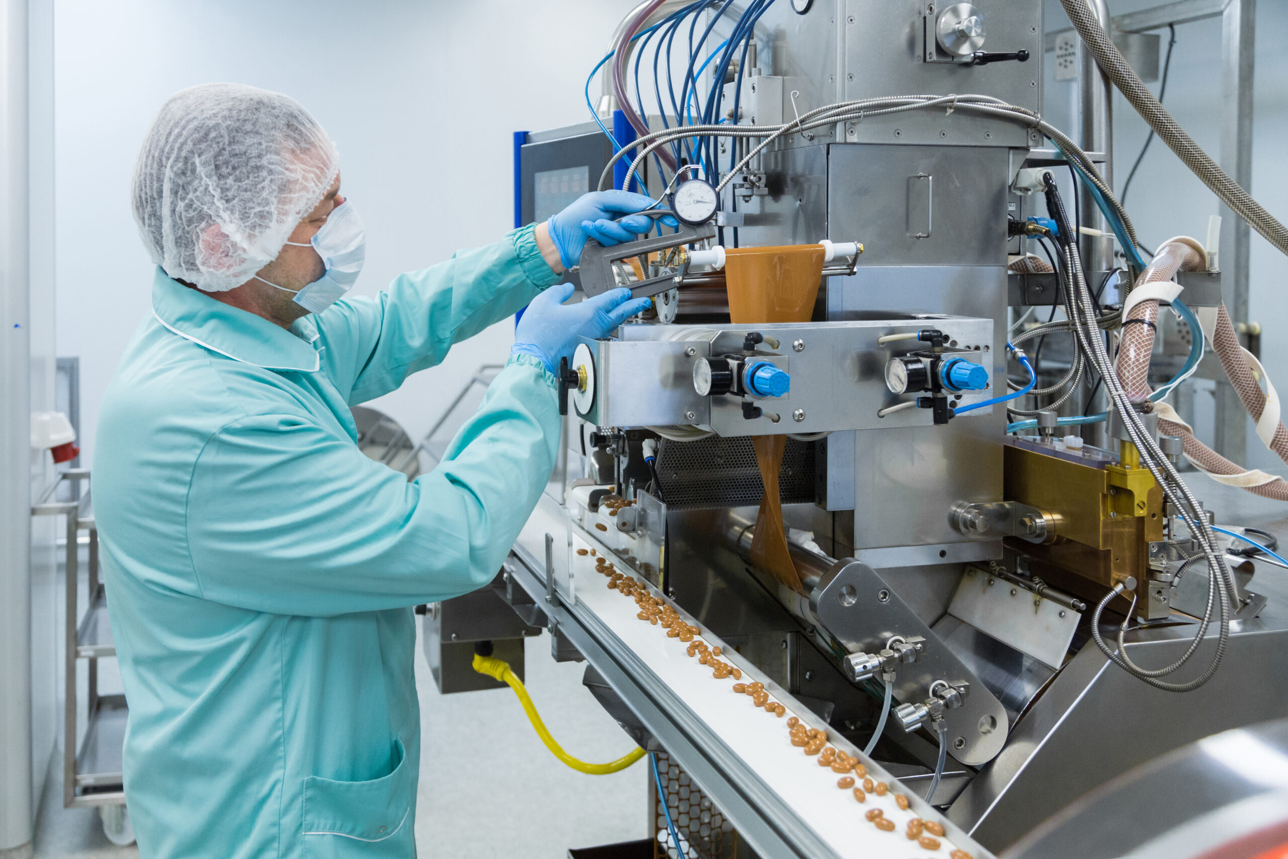 Pharmacy industry factory man worker in protective clothing in sterile working conditions
